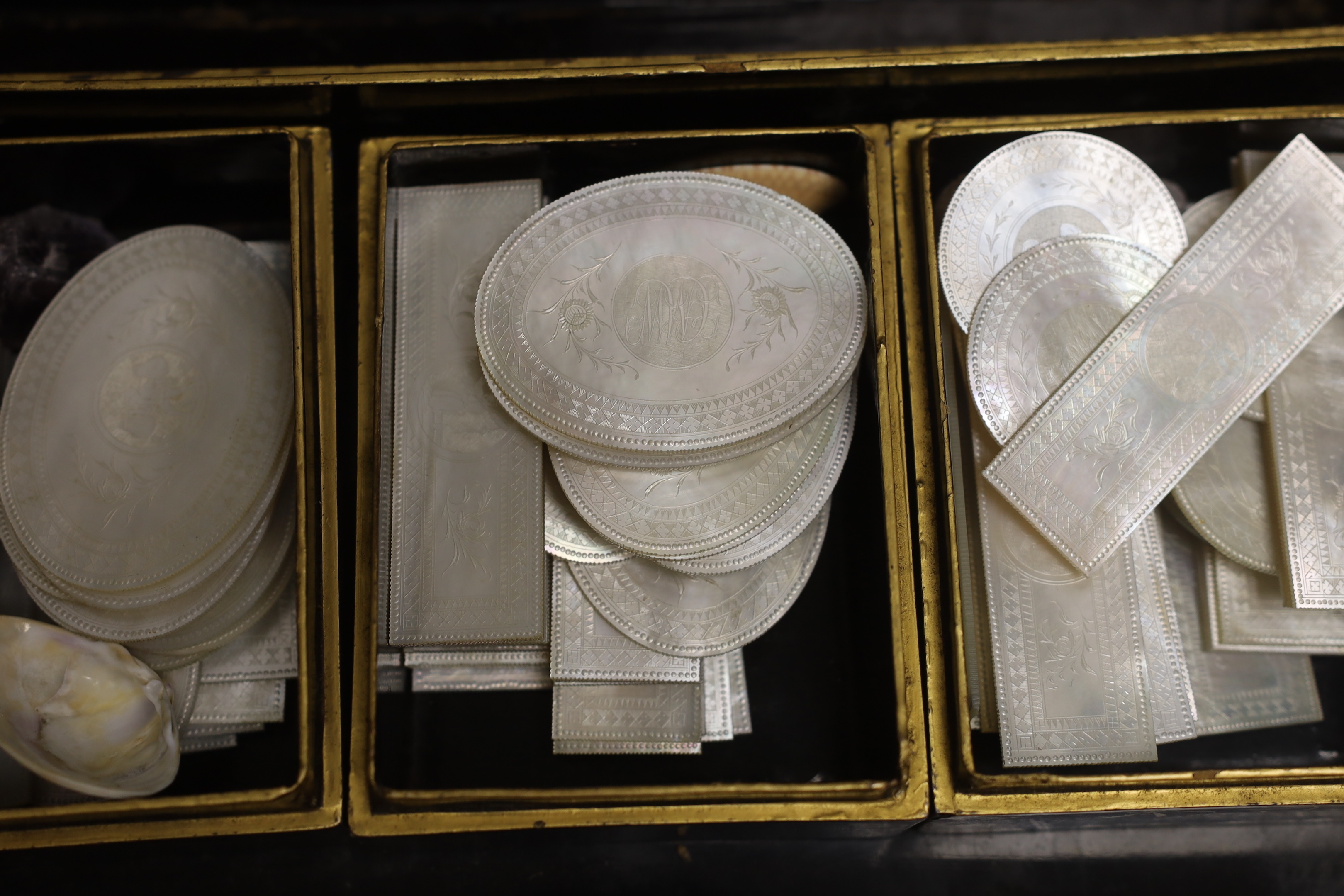 A 19th century Chinese export lacquer games box and mother of pearl counters